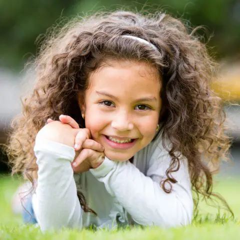 Young girl smiling outdoors