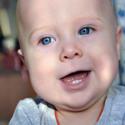 Baby showing bottom three teeth